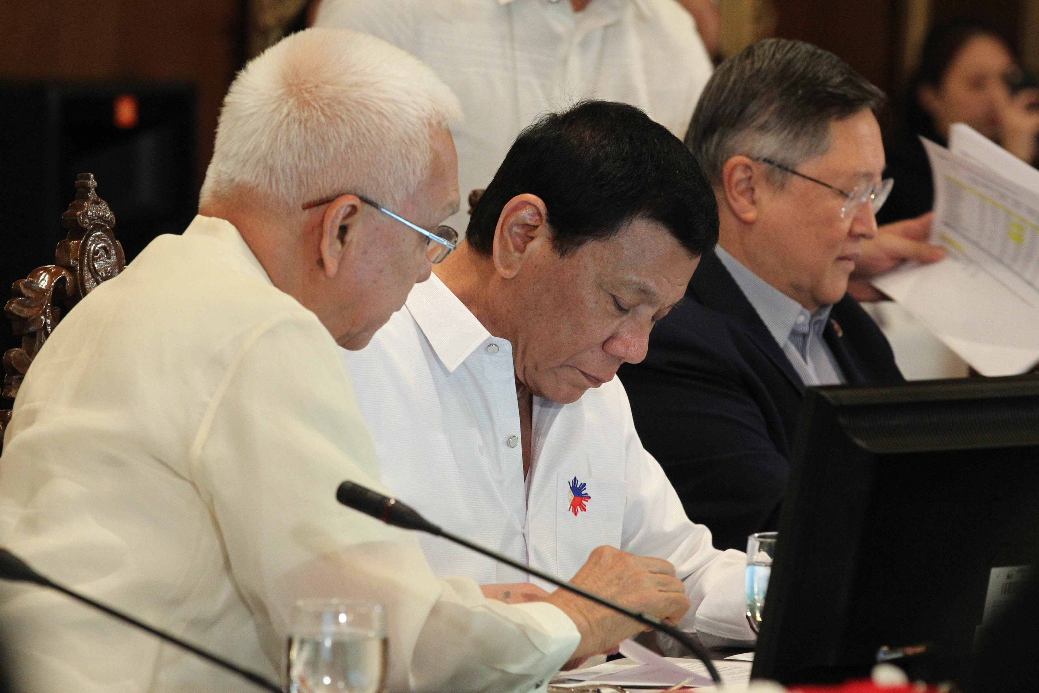 WORKING PRESIDENT. President Rodrigo Duterte reads documents during the 12th Cabinet meeting at the Palace. Photo from Presidential Photographers Division  