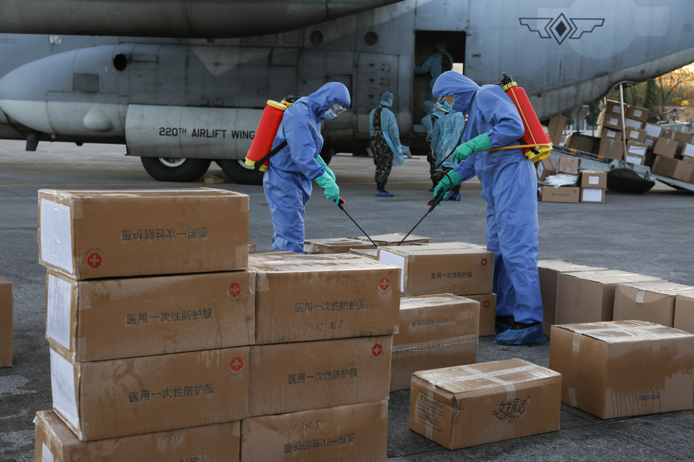 FILE PHOTO. The aid packages donated by the People's Republic of China undergo disinfection upon arrival at the Villamor Air Base in Pasay City on March 21, 2020. The donation includes assorted medical supplies, personal protective equipment, and testing kits for coronavirus. Malacañang photo 