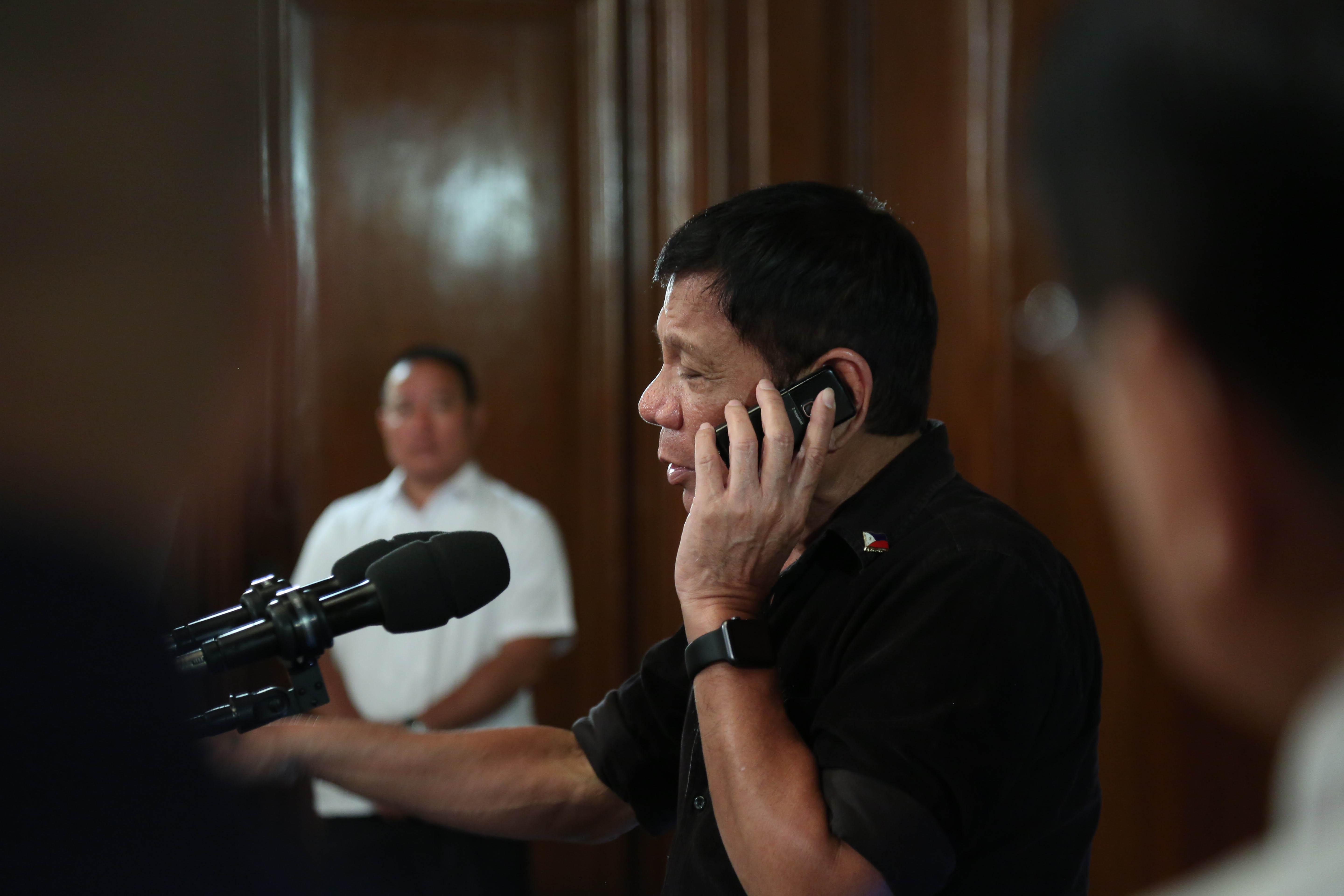 DO YOU HAVE LENI'S NUMBER? Asked if he intends to appoint Vice President Leni Robredo to the Cabinet, President Rodrigo Duterte calls to offer the HUDCC chairmanship during the taping of a media address in Malacañang on July 7, 2016. Malacañang Photo Bureau 