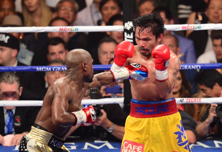 CONTROVERSY. Floyd Mayweather Jr and Manny Pacquiao fight in a welterweight unification bout on May 2, 2015 at the MGM Grand Garden Arena in Las Vegas, Nevada. Photo by Frederic J. Brown/AFP   