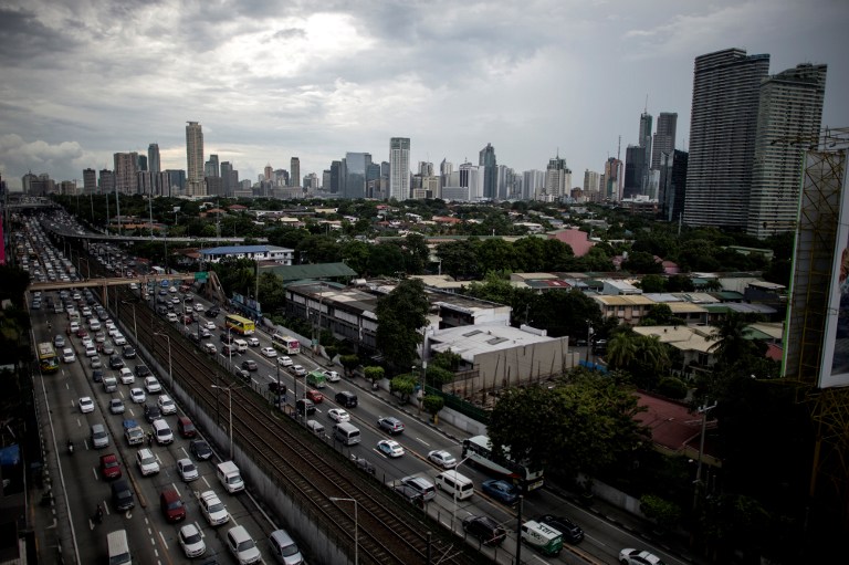 UNPRECEDENTED INFRA BUILDUP. This picture shows a general view of traffic as Manila's financial district is seen in the background. Photo by Noel Celis/AFP   