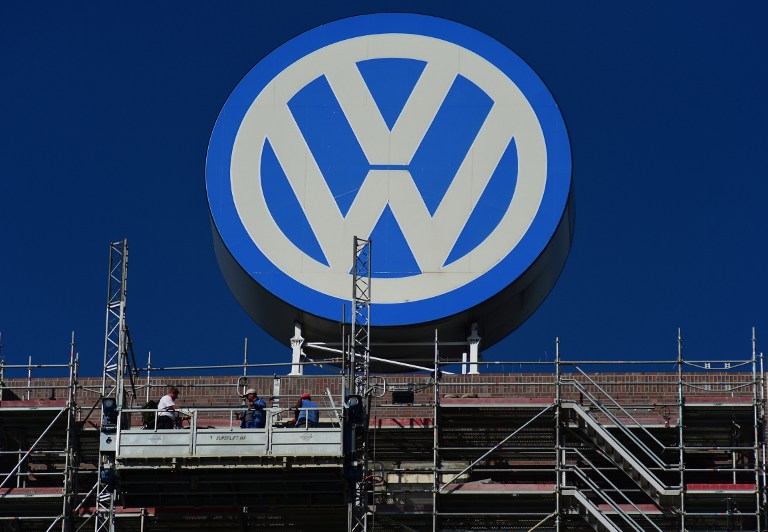 VOLKSWAGEN. A worker stands on a scaffold lift, under a giant VolksWagen logo at VolksWagen's original headquarters building, now under renovation in Wolfsburg, northern Germany, on September 30, 2015.File photo by John Macdougall/AFP 