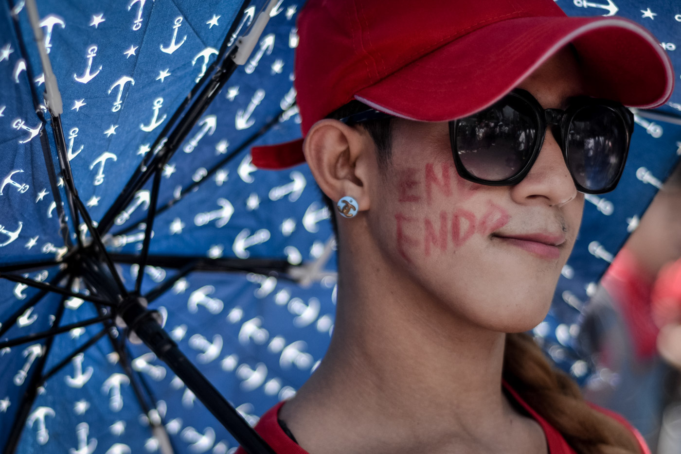 THE MESSAGE. Ash Mercado, 20, shows off her face paint, which reads, "End Endo," at the Labor Day rally in Mendiola, Manila, on Tuesday, May 1, 2018. Photo by Eloisa Lopez/Rappler 