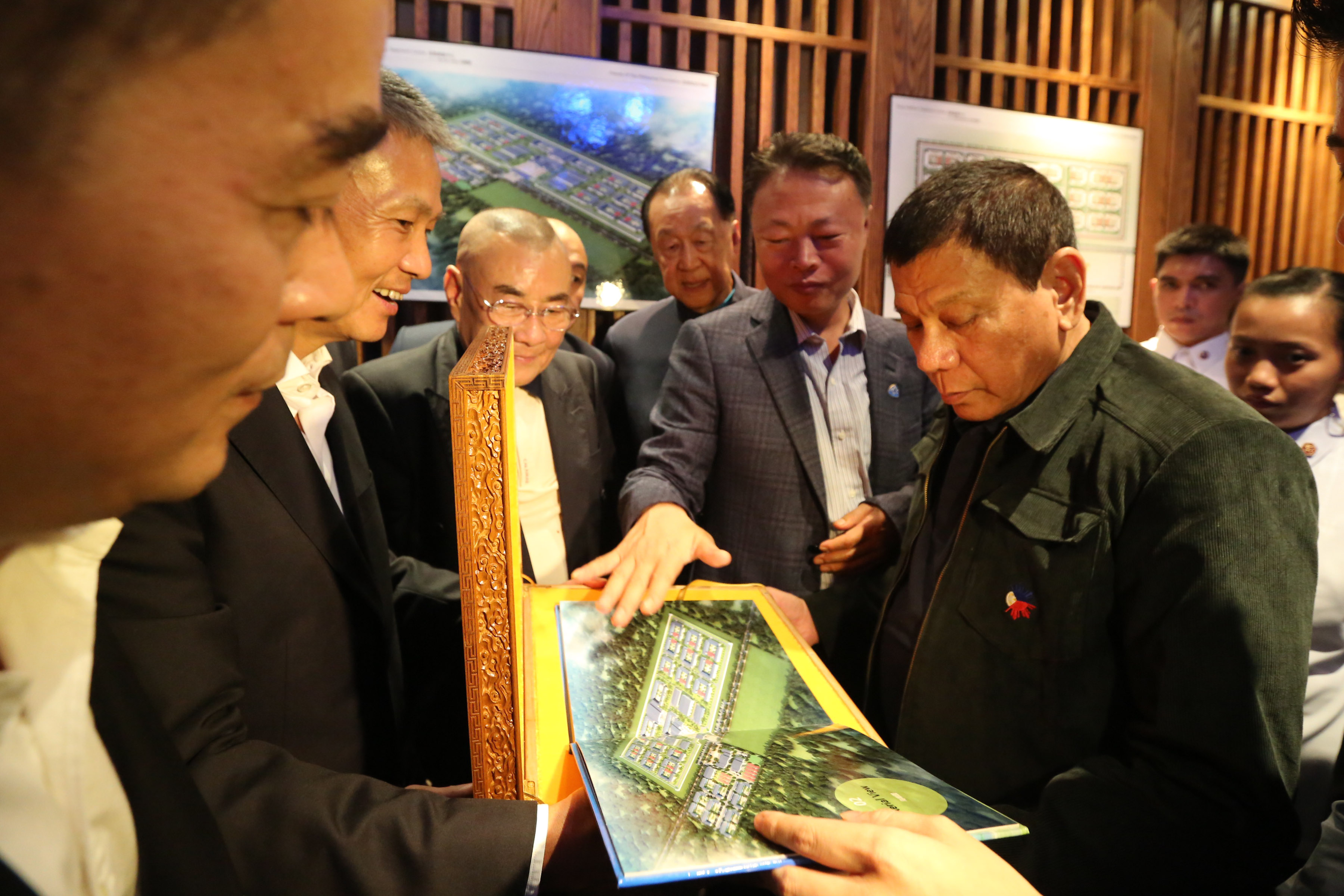 GIFT FROM FRIENDS. President Rodrigo Duterte receives the architect's perspective and blueprint of the proposed Drug Addiction Treatment Center to be donated by the Friends of the Philippines Foundation during a lunch meeting at Dadong Roast Duck Restaurant in Beijing, China on October 19, 2016. Photo by King Rodriguez/Presidential Photo  