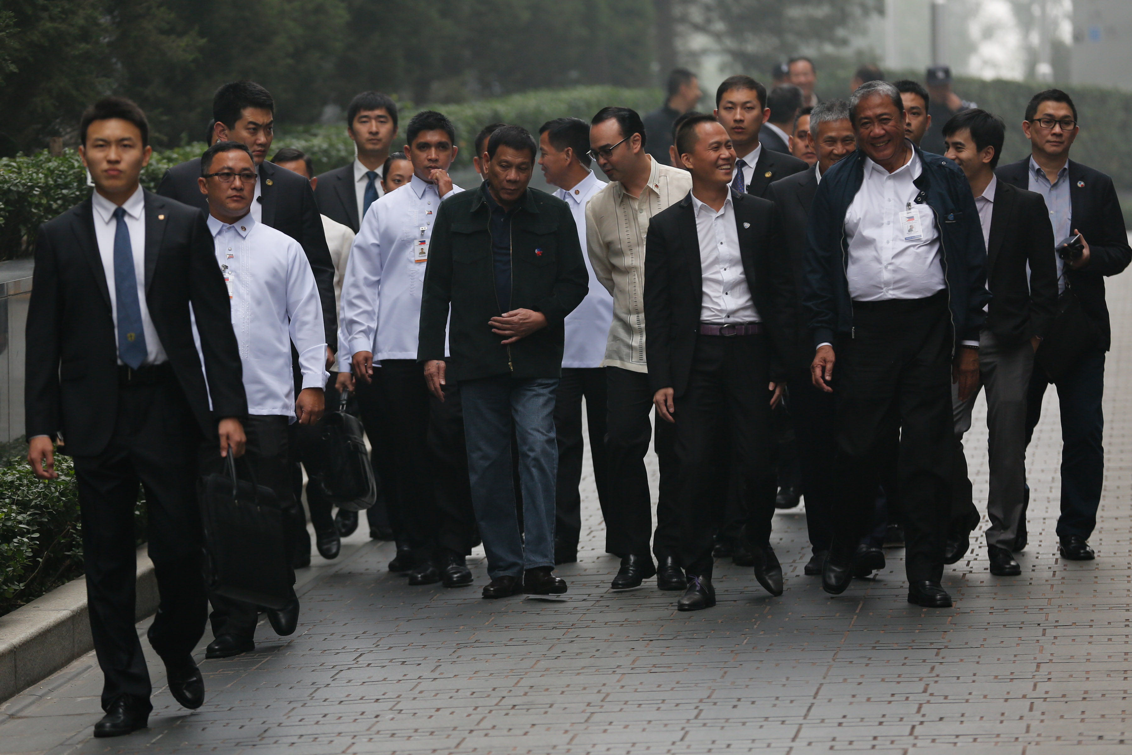 President Rodrigo Duterte is joined by Chinese Ambassador to the Philippines Zhiao Jianhua (right) and Senator Alan Peter Cayetano (left) as they walk along Wangfujing Street in Beijing China going to Dadong Roast Duck Restaurant for a lunch on October 19. Photo by King Rodriguez/Presidential Photo 
