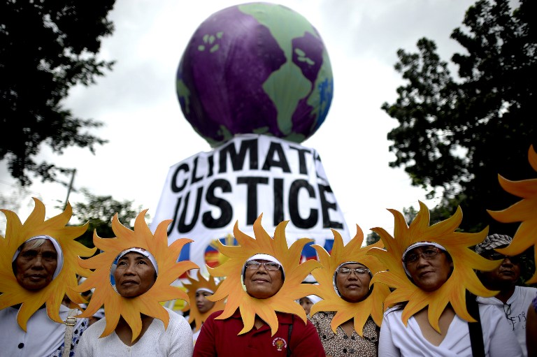CLIMATE JUSTICE. Protesters attend a climate change march on a highway in Manila on November 28, 2015. Noel Celis/AFP