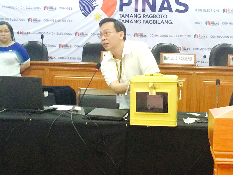EMS CODE IN BALLOT BOX. Comelec Commissioner Christian Robert Lim stands beside the ballot box, where the final trusted build of the EMS software for the 2016 polls is temporarily stored on Tuesday, January 26. On Wednesday morning, the software will be deposited to a BSP vault. Michael Bueza/Rappler 