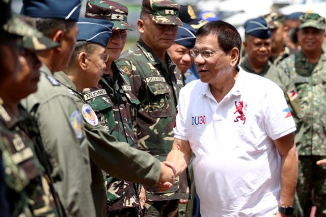 '100-PERCENT SUPPORT.' President Rodrigo Duterte is welcomed by officers of the Western Mindanao Command during his arrival at Edwin Andrews Airbase in Zamboanga City on July 21, 2016. KIWI BULACLAC/PPD 