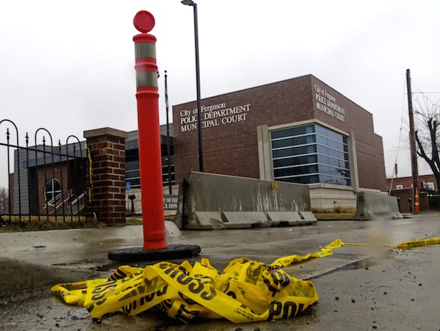 Police crime scene tape lies in the gutter outside the Ferguson Police Department at the spot where two police officers were shot during protests in Ferguson, Missouri, USA, 13 March 2015. Tannen Maury/EPA 