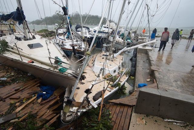 DESTROYED. A handout photo provided by UNICEF Pacific on March 14, 2015 of people looking at a severely damaged boats and yachts in a harbor on Vanuatu island, South Pacific region, March 14 2015. Graham Crumb/UNICEF Pacific/Handout/EPA 