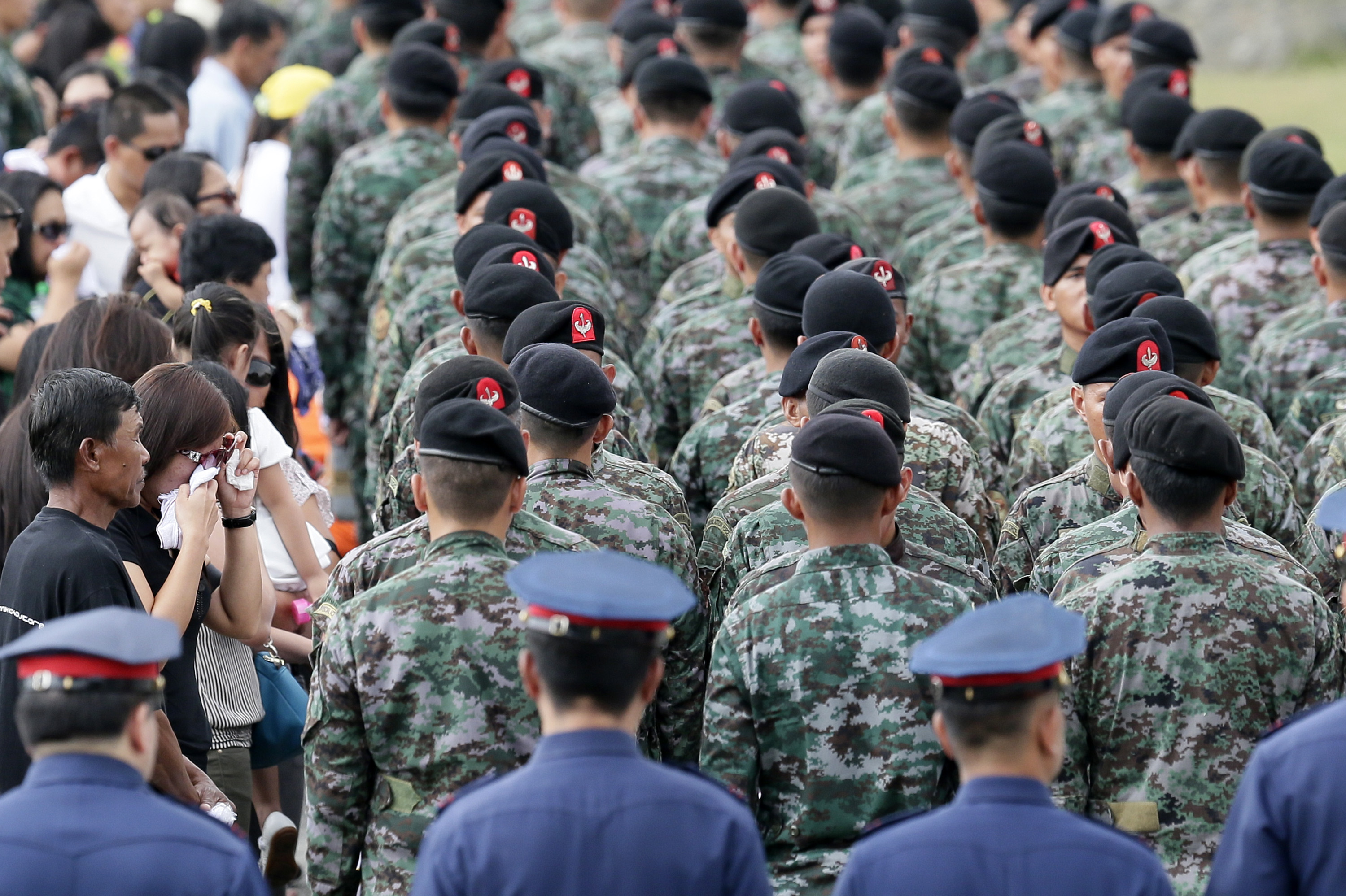 NATIONAL MOURNING. Families of slain elite Police Special Action Force pay their respect during arrival honors at Villamor Air Base on January 29. File photo by Dennis M. Sabangan/EPA