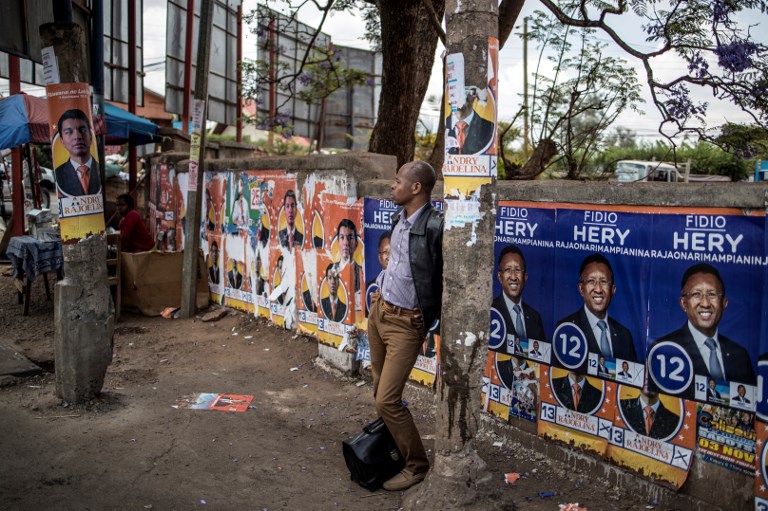 MADAGASCAR ELECTIONS. Electoral posters are seen at a bus stop in Antananarivo, on November 6, 2018, on the eve of in the first round of the presidential elections. Photo by Marco Longari/AFP 