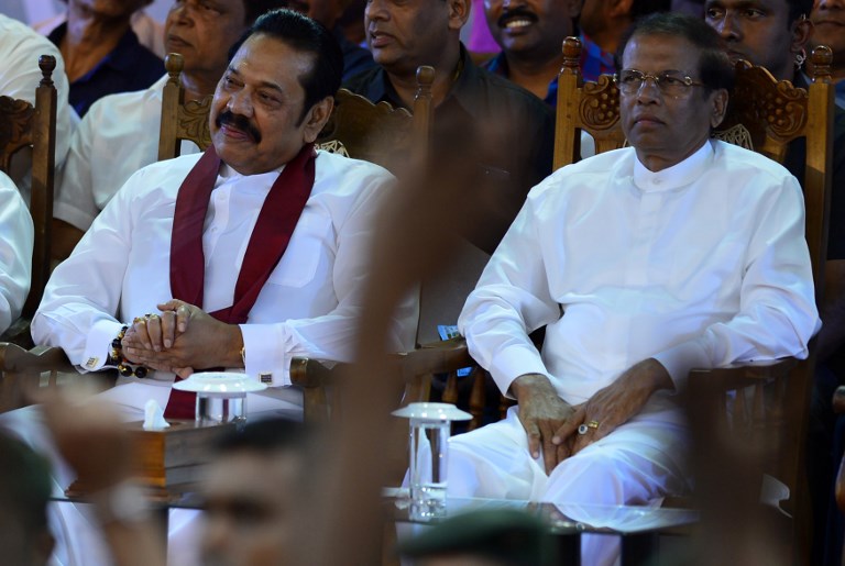 OUT. This file photo shows Sri Lanka's former president and prime minister Mahinda Rajapaksa (L) and President Maithripala Sirisena attending a rally in Colombo on November 5, 2018. Photo by Lakruwan Wanniarachchi/AFP  