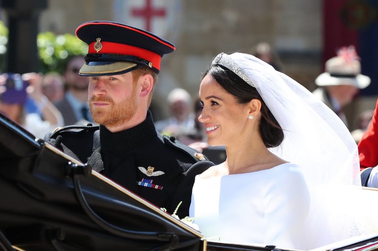 Britain's Prince Harry, Duke of Sussex and his wife Meghan, Duchess of Sussex begin their carriage procession in the Ascot Landau Carriage after their wedding ceremony at St George's Chapel, Windsor Castle, in Windsor, on May 19, 2018. File photo by Gareth Fuller/AFP 