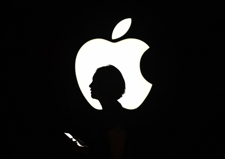 APPLE. In this file photo taken on September 9, 2015 a reporter walks by an Apple logo during a media event in San Francisco, California.Photo by Josh Edelson/AFP 