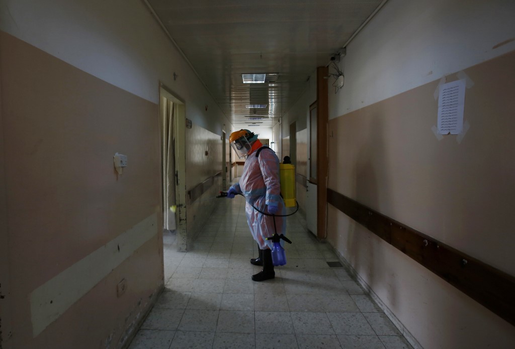 PANDEMIC. A Palestinian health team in protective gear disinfects bedrooms at Beit Jala Hospital, on March 11, 2020, near the West Bank city of Bethlehem which is under lockdown due to the novel coronavirus epidemic. Photo by Musa Al Shaer/AFP 