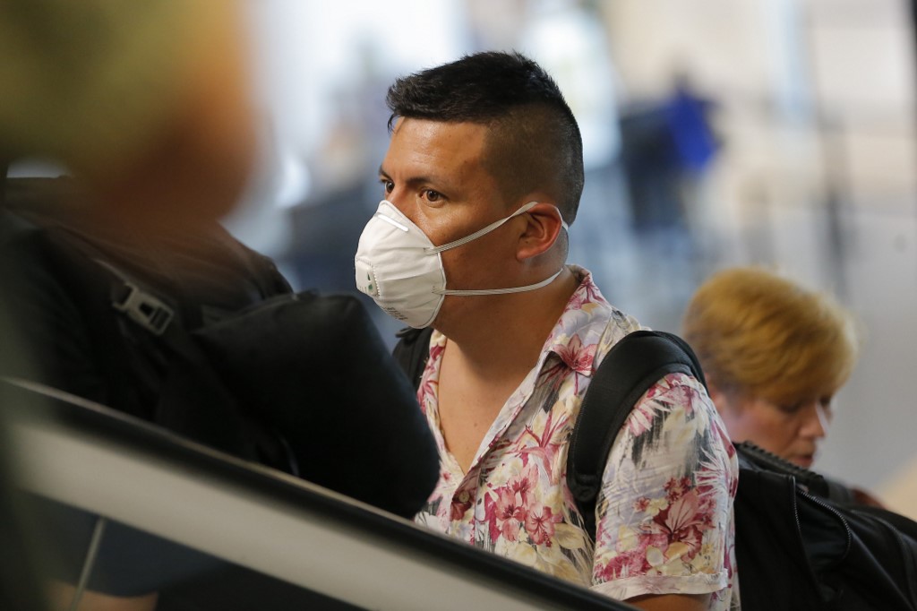 FLIGHT. A passenger wears a protective face mask as a precaution against the spread of the new coronavirus at Jorge Chavez International Airport, in Lima, on March 6, 2020. Photo by Luka Gonzales/AFP 
