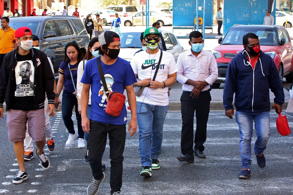 KUWAIT AND THE VIRUS. People wearing protective masks cross the street in Kuwait City on March 2, 2020, amid a global outbreak of the novel Coronavirus. Photo by Yasser Al-Zayyat/AFP 