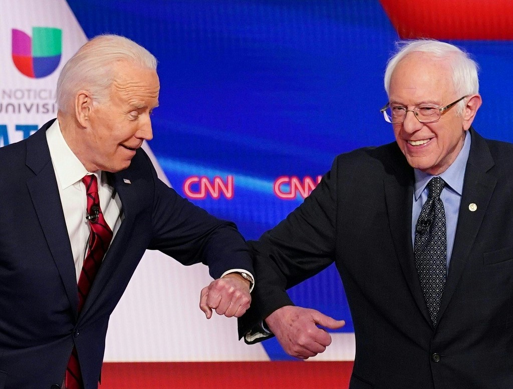 ELBOW BUMP. Democratic presidential hopefuls former US vice president Joe Biden (L) and Senator Bernie Sanders greet each other with a safe elbow bump before the start of the 11th Democratic Party 2020 presidential debate in a CNN Washington Bureau studio in Washington, DC on March 15, 2020. Photo by Mandel Ngan/AFP 