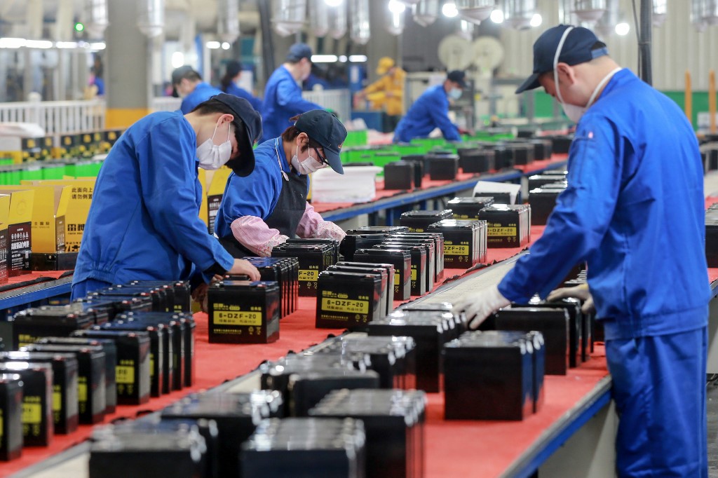 MANUFACTURING. Employees work on a battery production line at a factory in Huaibei in China's eastern Anhui province on March 30, 2020. Photo by AFP 