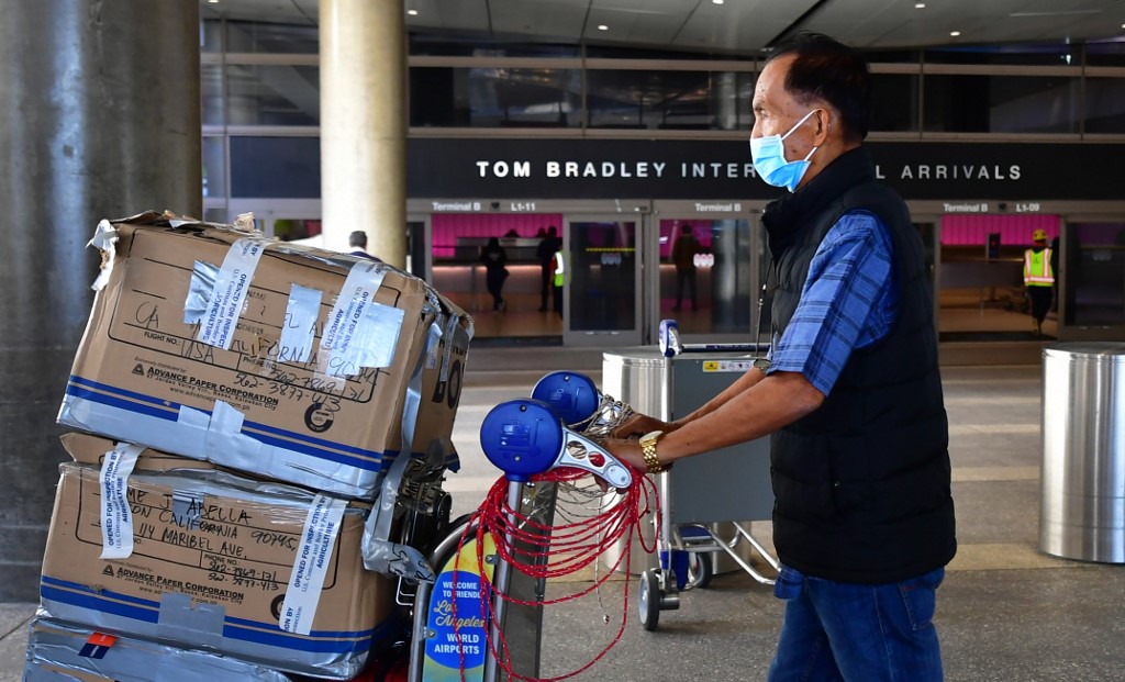 MASKED. A man wears a face mask at Los Angeles International Airport (LAX) in Los Angeles, California on March 2, 2020. Photo by Frederic J. Brown/AFP 