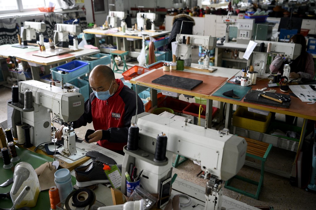 SLOWDOWN. A worker sews shoe parts at the Zhejiang Xuda Shoes Company factory in Wenzhou, China, on February 27, 2020. Photo by Noel Celis/AFP 