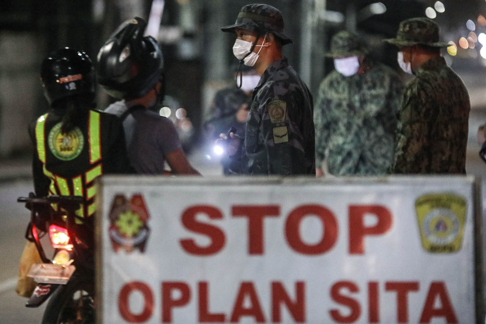 CHECKPOINT. Quezon City police check for signs and symptoms of the novel coronavirus among those passing through a checkpoint on Sgt Esguerra St. in Quezon Cit. File photo by Darren Langit/Rappler