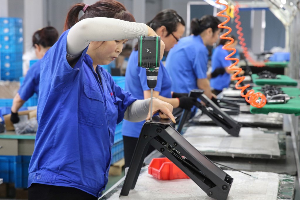 MANUFACTURING. Workers produce desks at a factory in Nantong in China's eastern Jiangsu province on September 4, 2019. File photo by AFP 