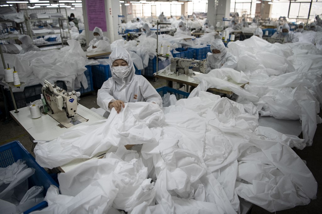 HAZMAT SUITS. Workers sew hazardous material suits to be used in the novel coronavirus outbreak, at the Zhejiang Ugly Duck Industry Company's garment factory in Wenzhou, China, on February 28, 2020. Photo by Noel Celis/AFP 