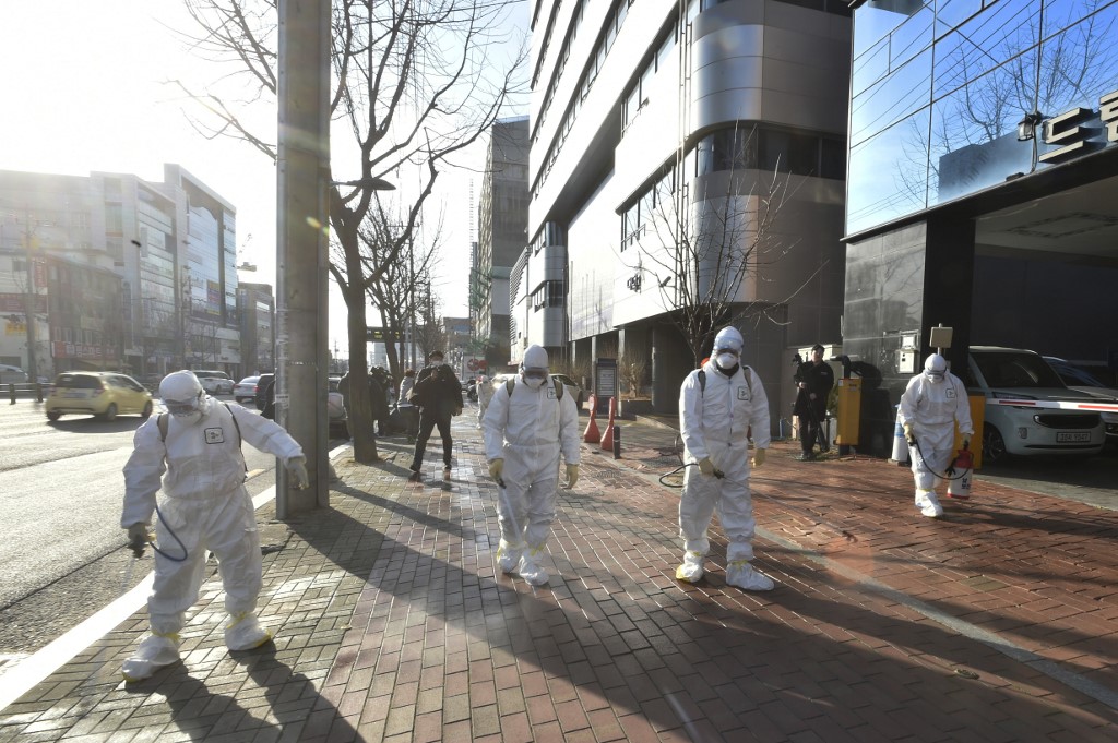 DISINFECTION. This handout picture taken on February 19, 2020 shows South Korean health officials wearing protective suit and spraying disinfectant in front of the Daegu branch of the Shincheonji Church of Jesus. Photo by Daegu Metropolitan City Namgu/AFP 