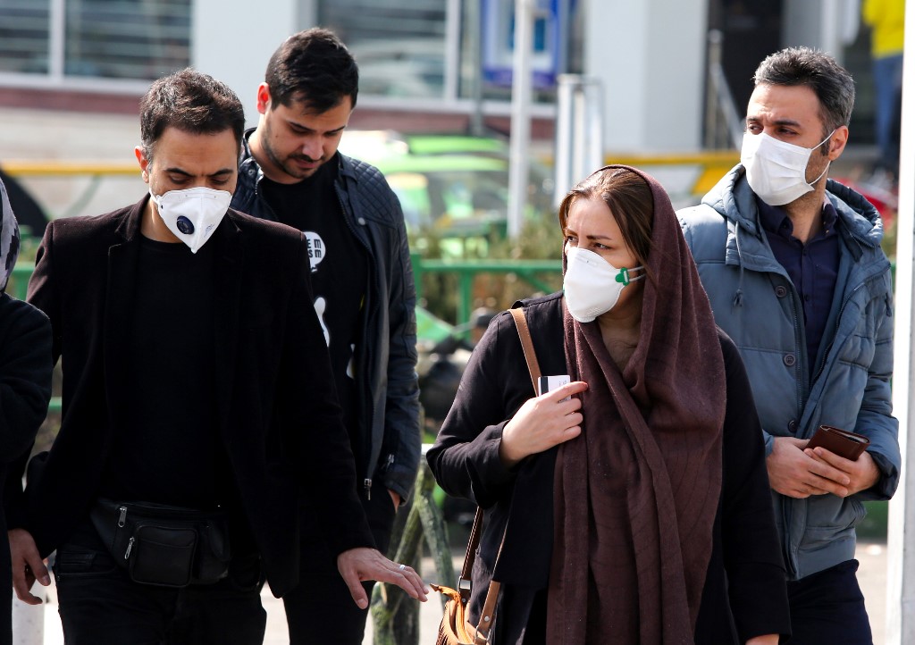 CORONAVIRUS SPREAD. Iranians wear protective masks in the capital Tehran on February 22, 2020 as the 2019 novel coronavirus spreads in the country. Photo by Atta Kenare/AFP  