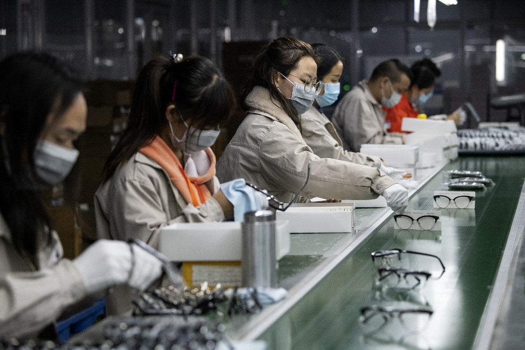 MANUFACTURING. Workers wearing face masks polish eyeglass frames at the Azure Eyeglasses Company in Wenzhou, China, on February 28, 2020. Photo by Noel Celis/AFP 