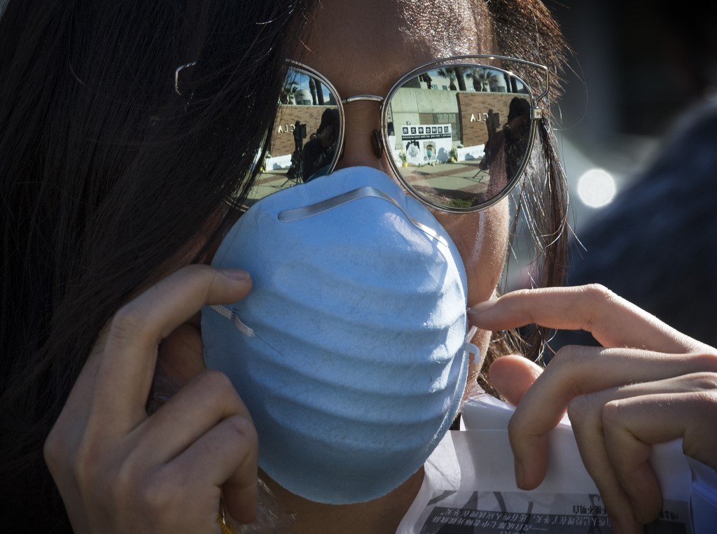 MASKED. Chinese students hold a memorial for Dr Li Wenlian outside the UCLA campus in Westwood, California, on February 15, 2020. Photo by Mark Ralston/AFP 
