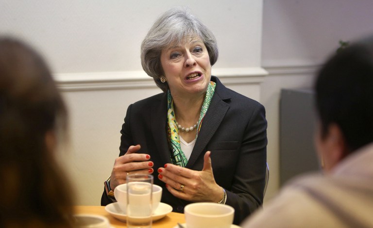 BREXIT. In this file photo, British Prime Minister Theresa May (C) reacts during her visit to the Wellbeing Centre in Aldershot, south-west of London, January 9, 2017. File photo by Steve Parsons/Pool/AFP 