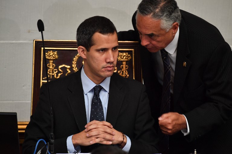GUAIDO. Venezuela's National Assembly head and self-proclaimed 'acting president' Juan Guaido (L), listens to deputy Rafael Veloz, during a session at the National Assembly in Caracas on January 29, 2019. Photo by Yuri Cortez/AFP 