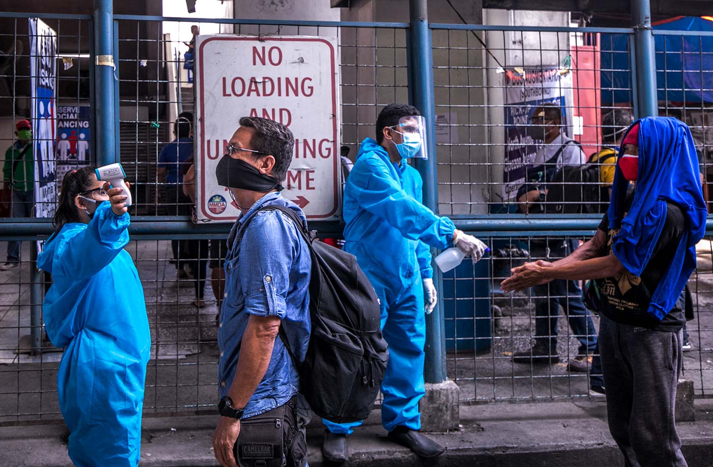 DISINFECTION. North Avenue MRT 3 Station personnel disinfect and check passengers to maintain the strict health protocol imposed by the management after hundreds of workers tested positive for COVID-19. Photo by Darren Langit/Rappler  