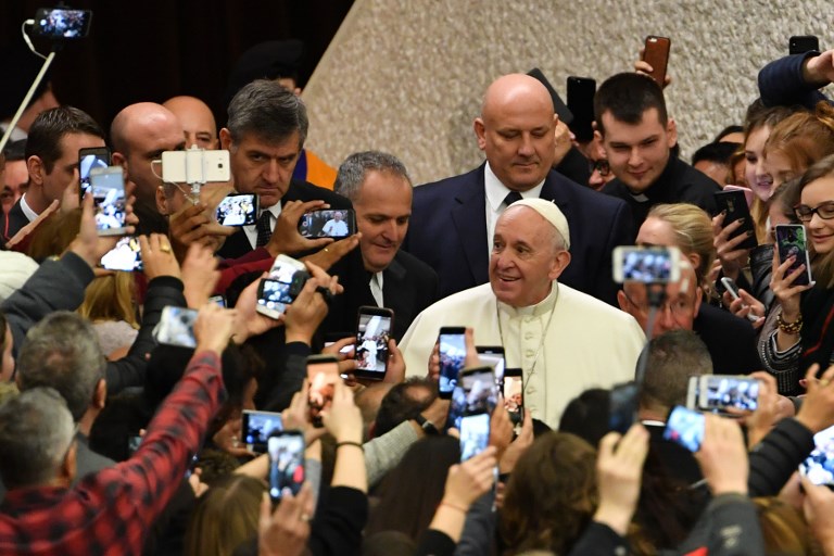 POPE FRANCIS. The faithful greet and take photos of Pope Francis (R) as he arrives for the weekly general audience at Paul-VI hall on January 30, 2019 at the Vatican. Photo by Andreas Solaro/AFP 