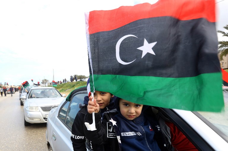 LIBYA POLLS. Libyan children wave their national flag in the capital Tripoli during a celebration to mark the the upcoming eighth anniversary of the Libyan revolution which toppled strongman Moamer Kadhafi, on February 25, 2019. Photo by Mahmud Turkia/AFP 