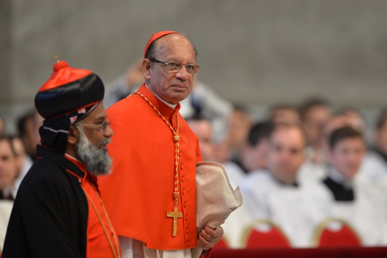 'TAKE AN HONEST LOOK.' Indian cardinal Oswald Gracias (R) arrives for a grand mass in St Peter's Basilica ahead of a papal election conclave on March 12, 2013 in St Peter's basilica at the Vatican. File photo by Gabriel Bouys/AFP  