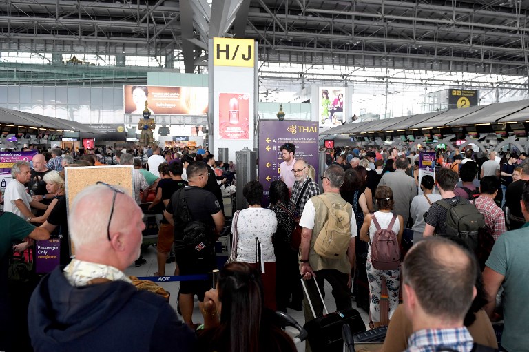 STRANDED IN THAILAND. Stranded passengers wait at the check-in area at the Suvarnabhumi International Airport in Bangkok on February 28, 2019. Photo by Lillian Suwanrumpha/AFP 