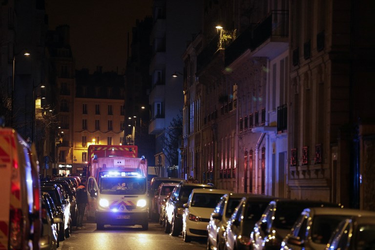 Firefighters are seen near a building that caught fire in the 16th arrondissement in Paris, on February 5, 2019. Photo by Geoffroy van der Hasselt/AFP 