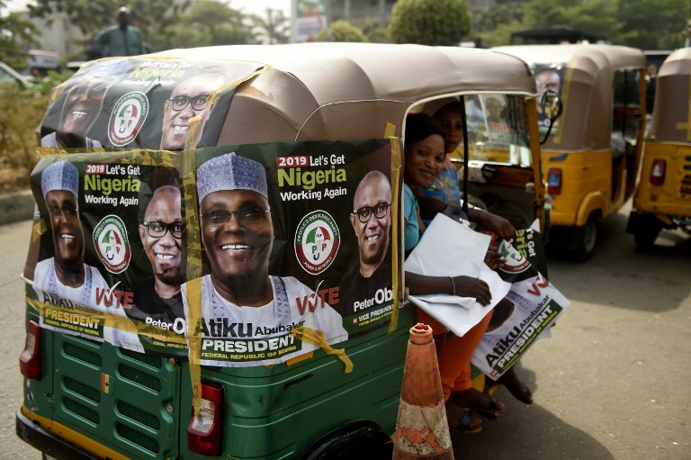 ELECTIONS. Rickshaws emblazoned with campaign posters bearing images of the opposition Peoples Democratic Party election candidate Atiku Abubakar and his running mate Peter Obi stand on a road in Abuja on February 19, 2019, ahead of rescheduled general elections. Photo by Pius Utomi Ekpei/AFP 