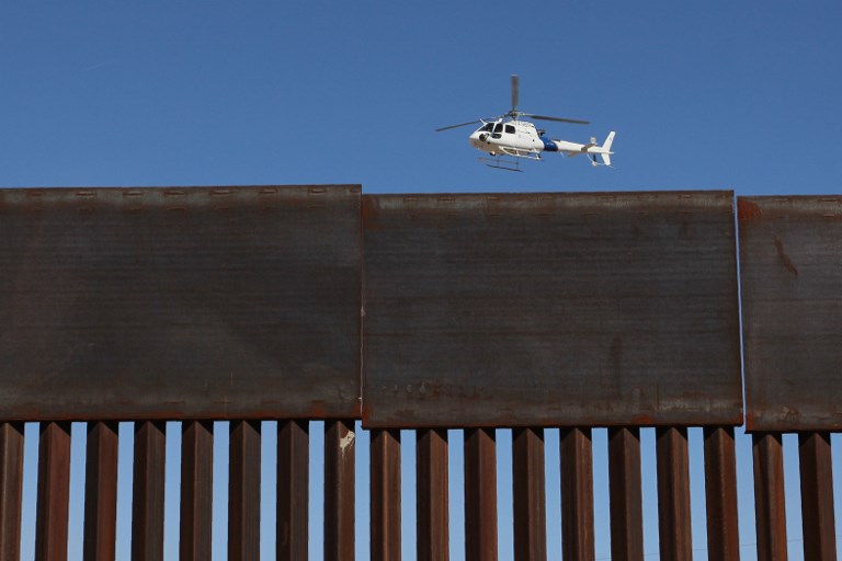 BORDER WALL QUESTIONS. A US Customs and Border Protection helicopter flies over the border wall during a safety drill in the Anapra area in Sunland Park, New Mexico, United States, across from Ciudad Juarez, Chihuahua state, Mexico, on January 31, 2019. Photo by Herika Martinez/AFP 