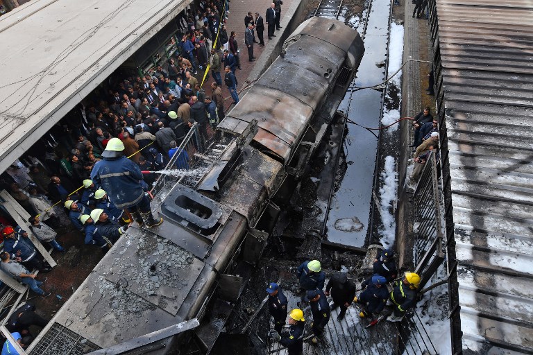 DEADLY CRASH. Fire fighters and onlookers gather at the scene of a fiery train crash at the Egyptian capital Cairo's main railway station on February 27, 2019. Photo by Stringer/AFP 