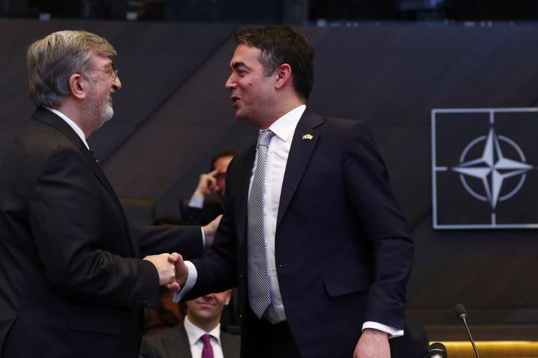 ACCESSION. NATO Permanent Representatives for Greece Spiros Lambridis (L) shakes hands with Macedonian Foreign Minister Nikola Dimitrov after the signature ceremony of the accession protocol between the Republic of North Macedonia and NATO at alliance headquarters in Brussels, Belgium on February 6, 2019. Photo by Francois Lenoir/Pool/AFP 