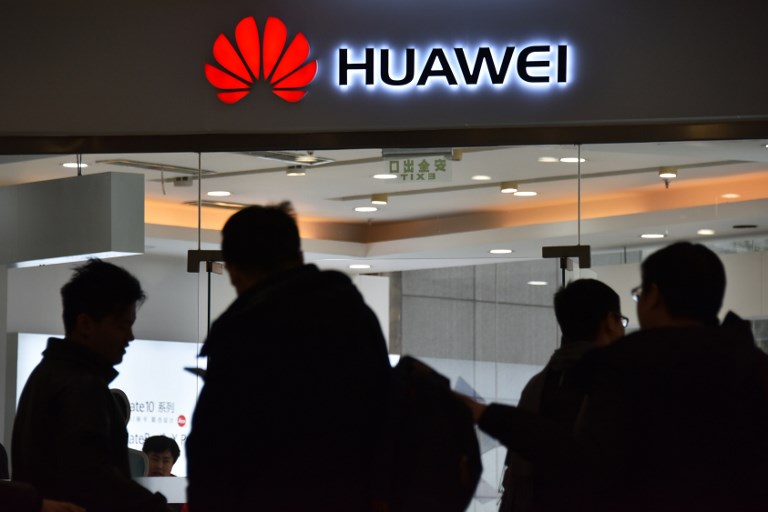 SECURITY CONCERNS. People walk past a Huawei store in Beijing, China, on December 10, 2018. File photo by Greg Baker/AFP 