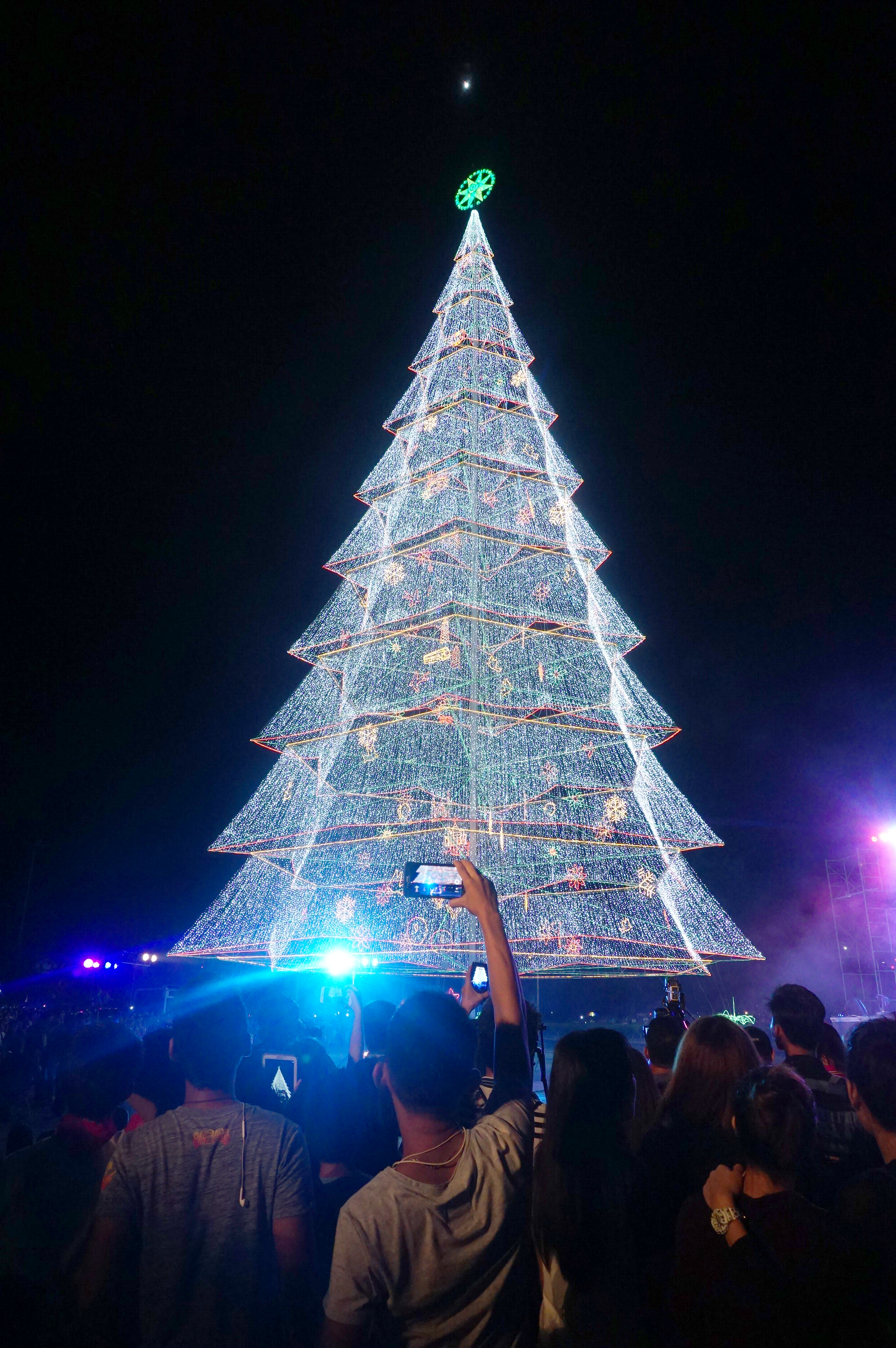 A man records in his mobile phone footage of the giant holiday tree of Tagum. Photo by Louie Lapat  