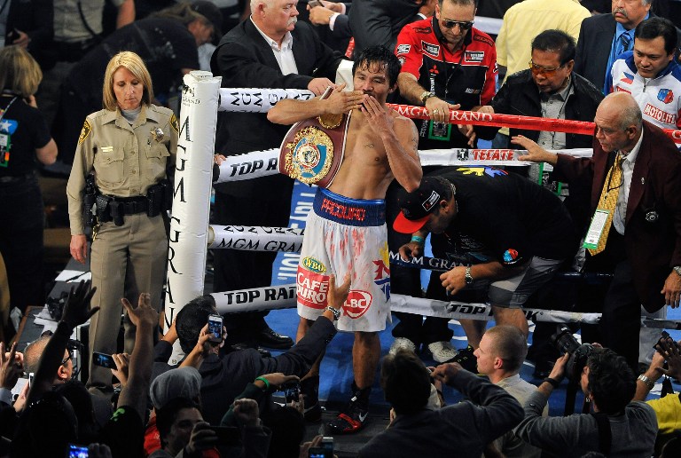 Manny Pacquiao celebrates after his unanimous decision victory over Timothy Bradley during their WBO world welterweight championship boxing match at the MGM Grand Garden Arena on April 12, 2014 in Las Vegas, Nevada. David Becker/Getty Images/AFP