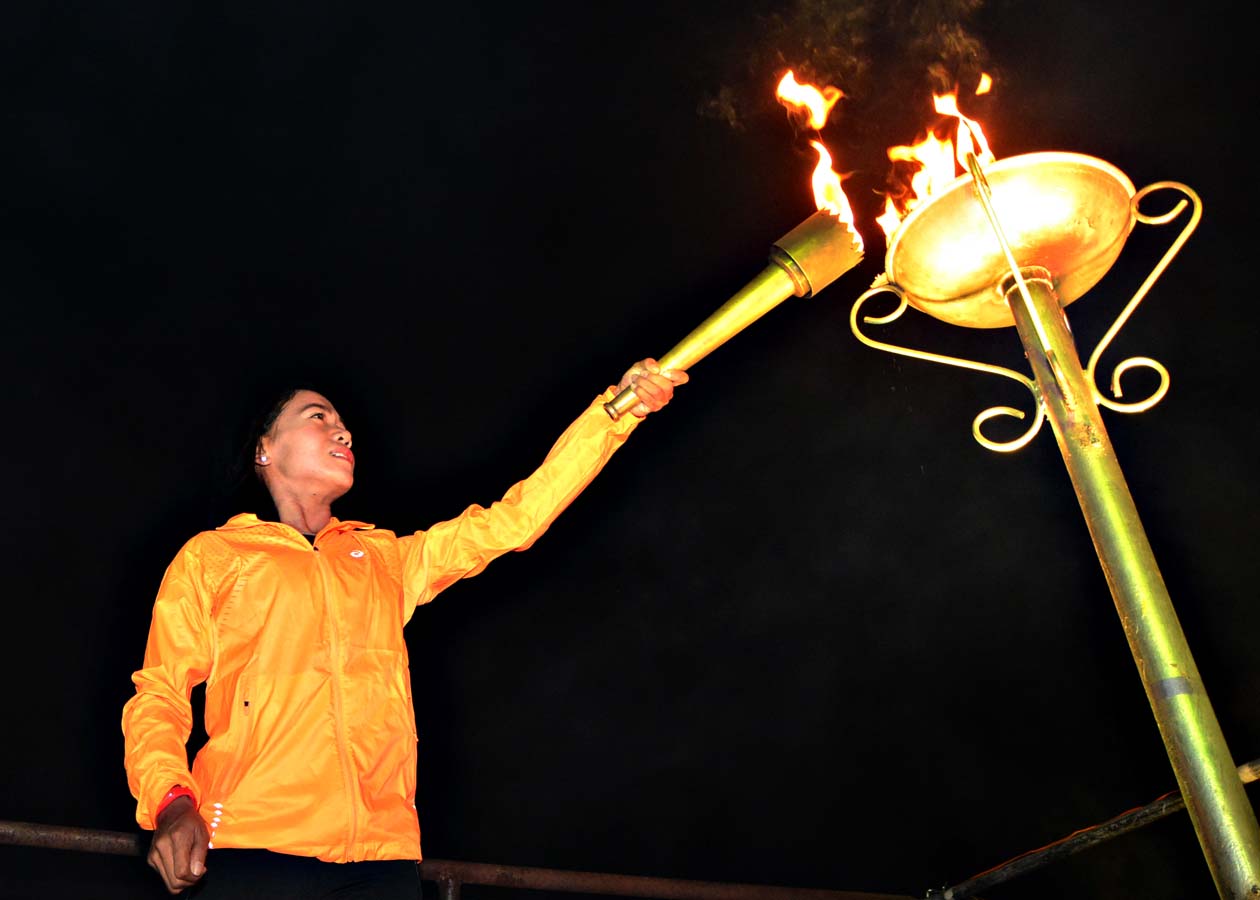 Mary Joy Tabal lights the flame at the 2015 Batang Pinoy National Finals held in Cebu City. Photo by Nathan Soriano  