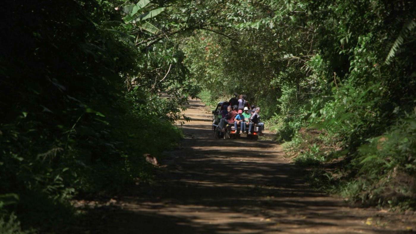 LACK OF CONCRETE ROADS. Children riding a small truck pass through rough roads in Binidayan. Photo by Adrian Portugal/Rappler 